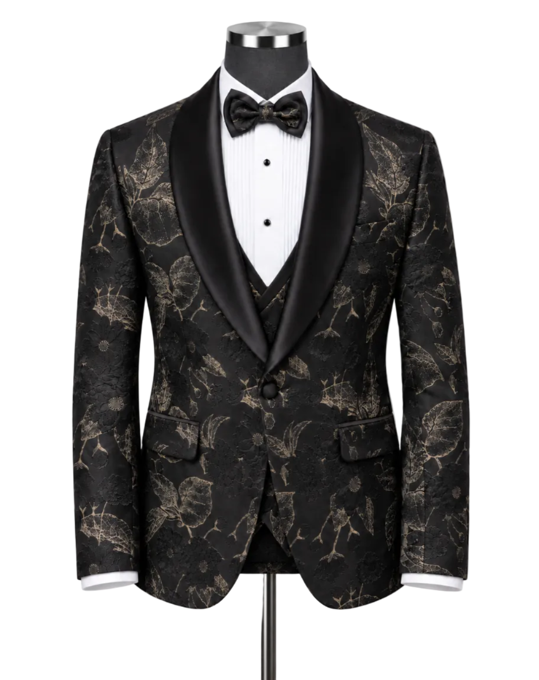 A men's tuxedo jacket displayed on a mannequin torso, featuring a black and gold floral brocade pattern with black satin shawl lapels, styled with a white pinstripe shirt, black bow tie, and matching vest.