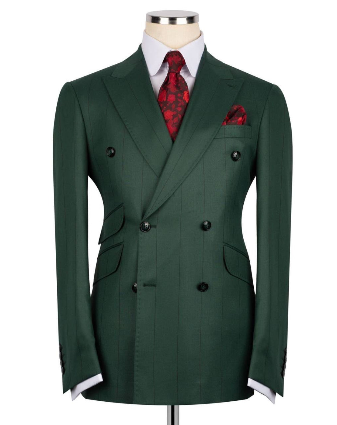 A dark green double-breasted suit jacket displayed on a mannequin torso, styled with a white dress shirt, a red patterned tie, and a matching red pocket square against a plain white background.