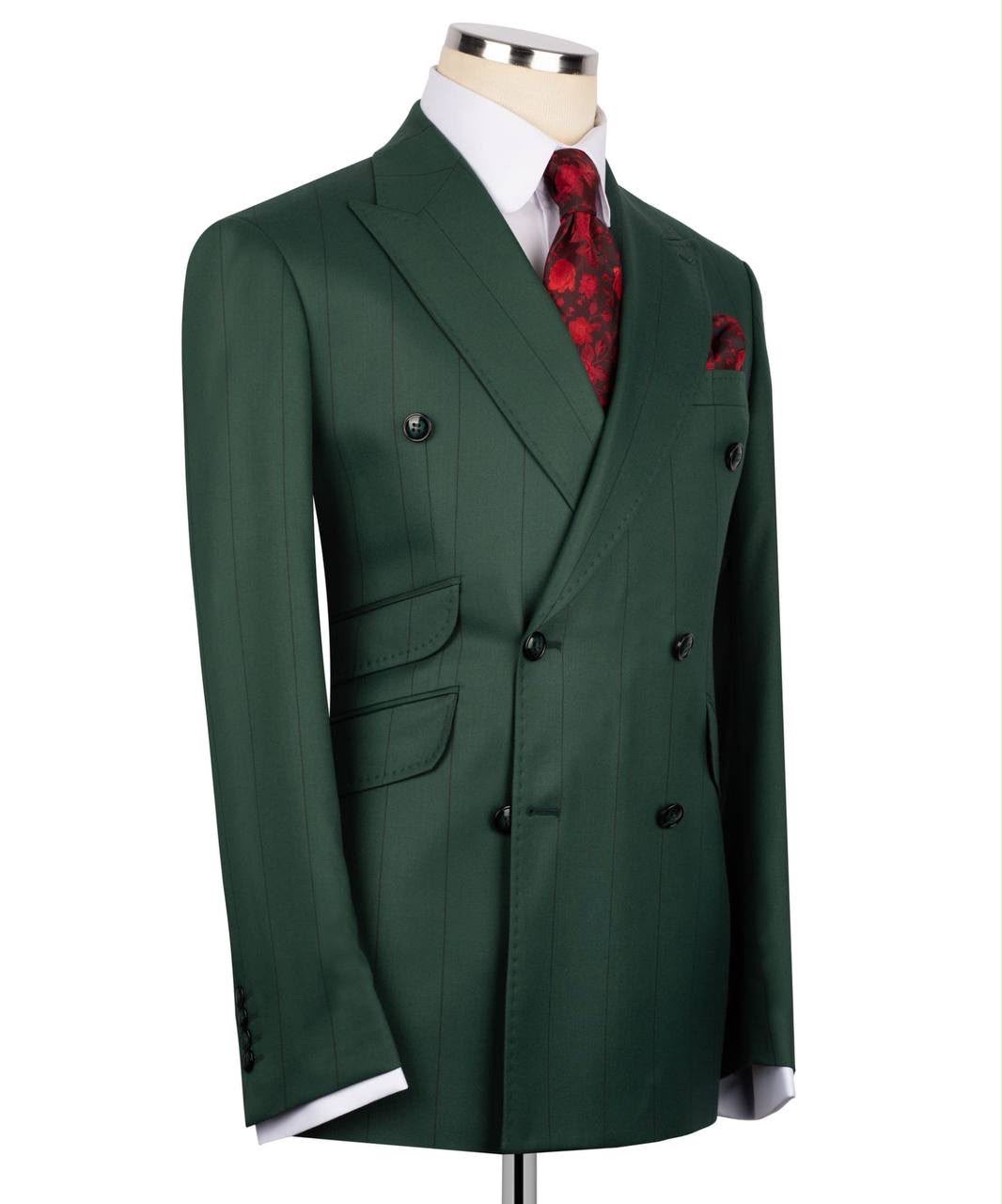 A dark green double-breasted suit jacket displayed on a mannequin torso, styled with a white dress shirt, a red patterned tie, and a matching red pocket square against a plain white background.