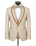 A beige tuxedo jacket with ornate gold beaded trim along the shawl collar, displayed on a mannequin with a white dress shirt, white bow tie, and matching beige vest.