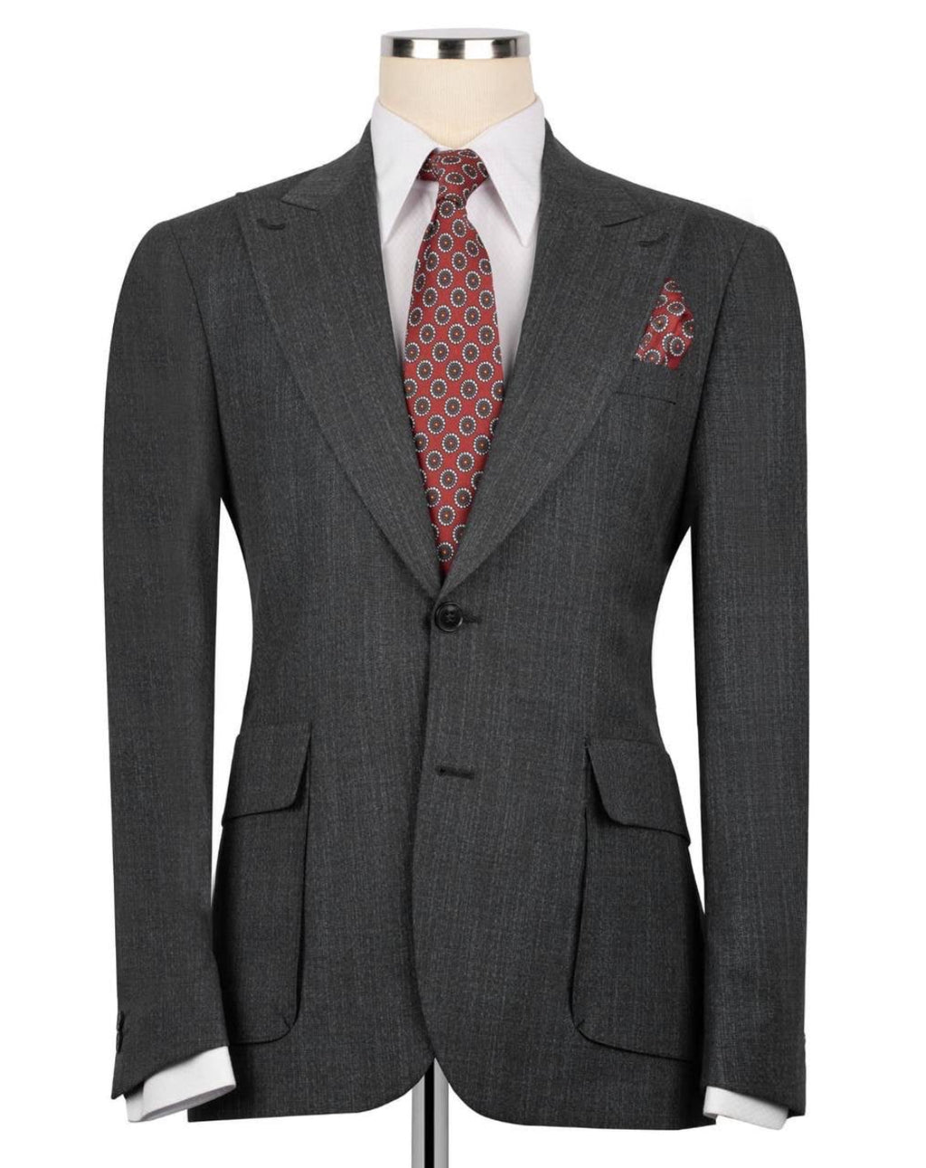 A dark gray textured wool suit jacket displayed on a mannequin torso, styled with a white dress shirt, a red and gold patterned tie, and a matching pocket square.