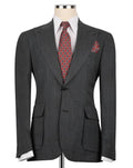 A dark gray textured wool suit jacket displayed on a mannequin torso, styled with a white dress shirt, a red and gold patterned tie, and a matching pocket square.