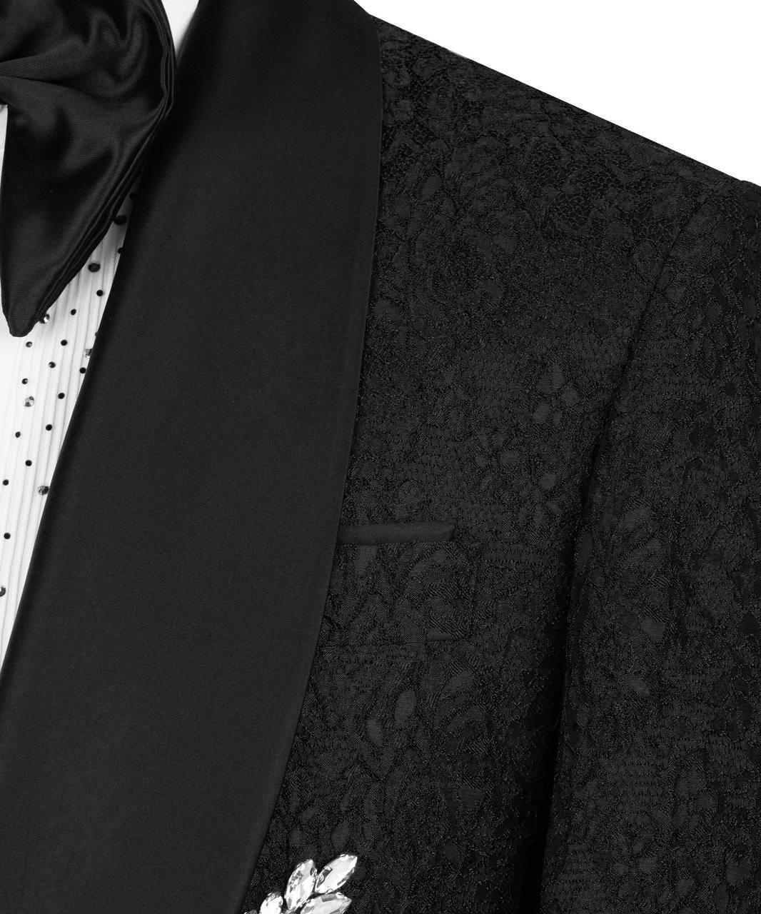 Close-up of a black tuxedo with a bow tie and floral details on a white background