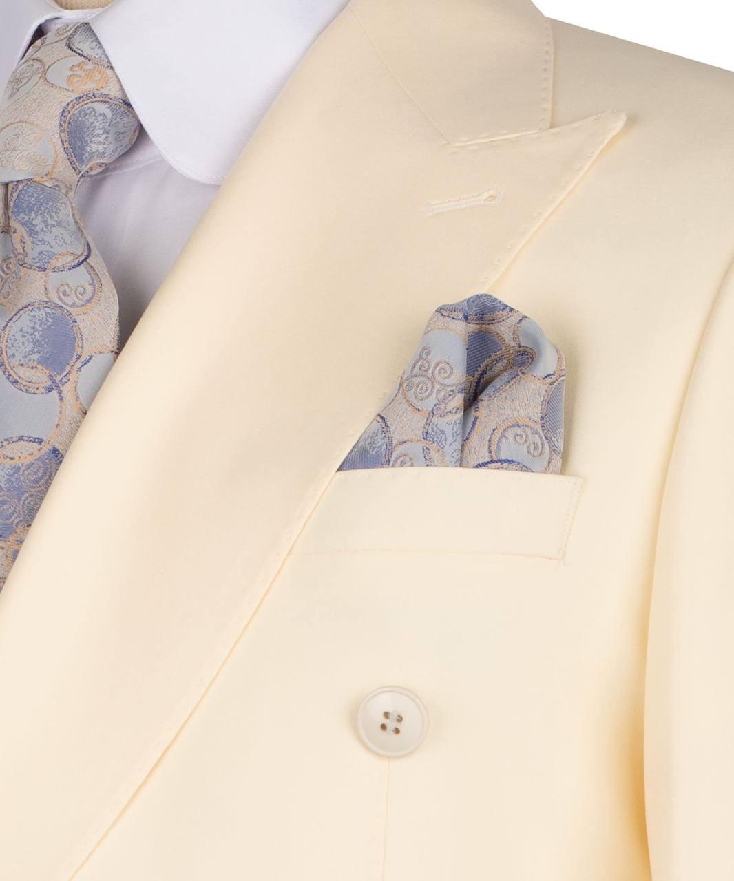 A close-up of a cream-colored double-breasted suit jacket with a white dress shirt and a patterned blue and gold pocket square.