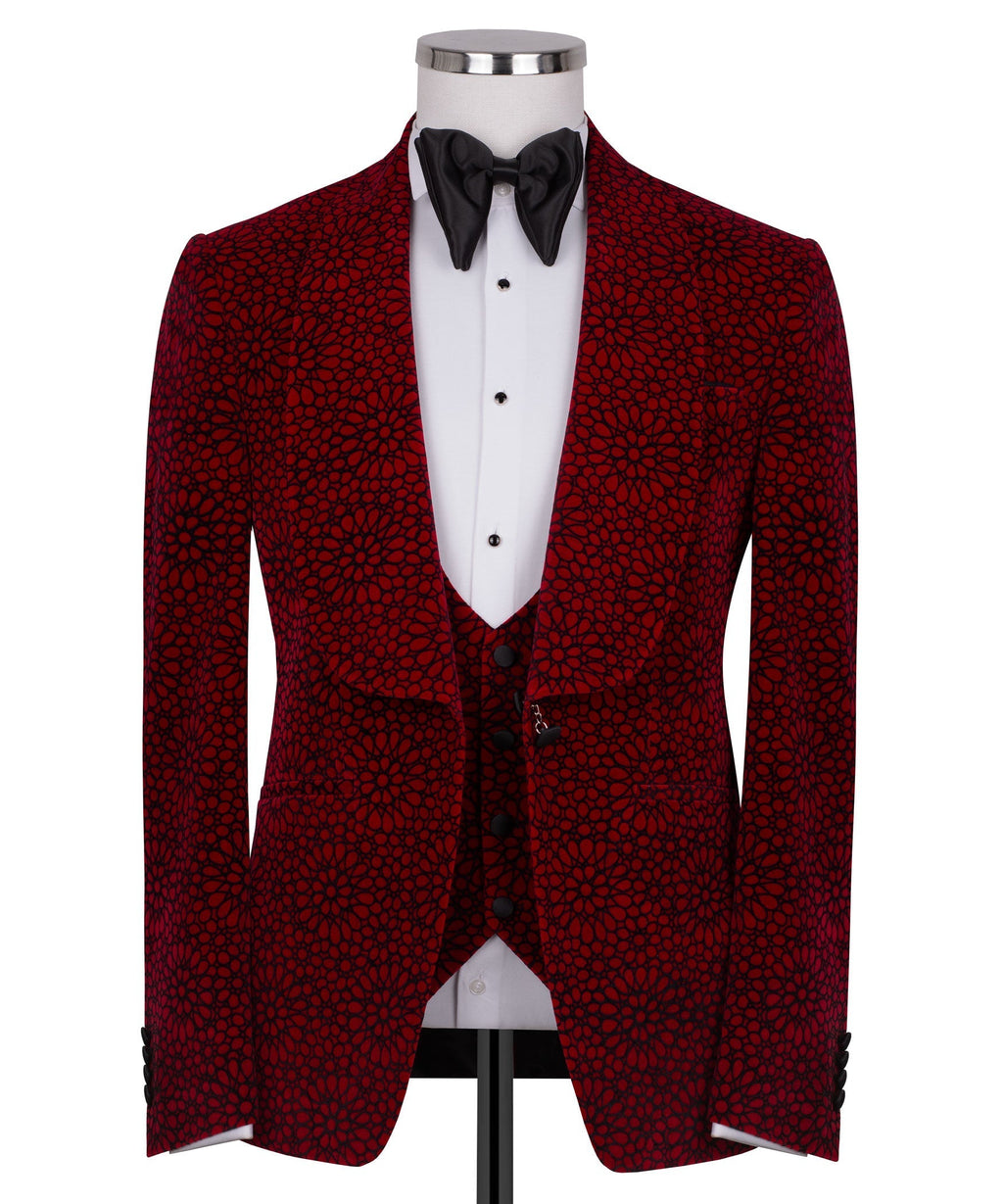 Red patterned tuxedo jacket with black satin bow tie over white vest and shirt
