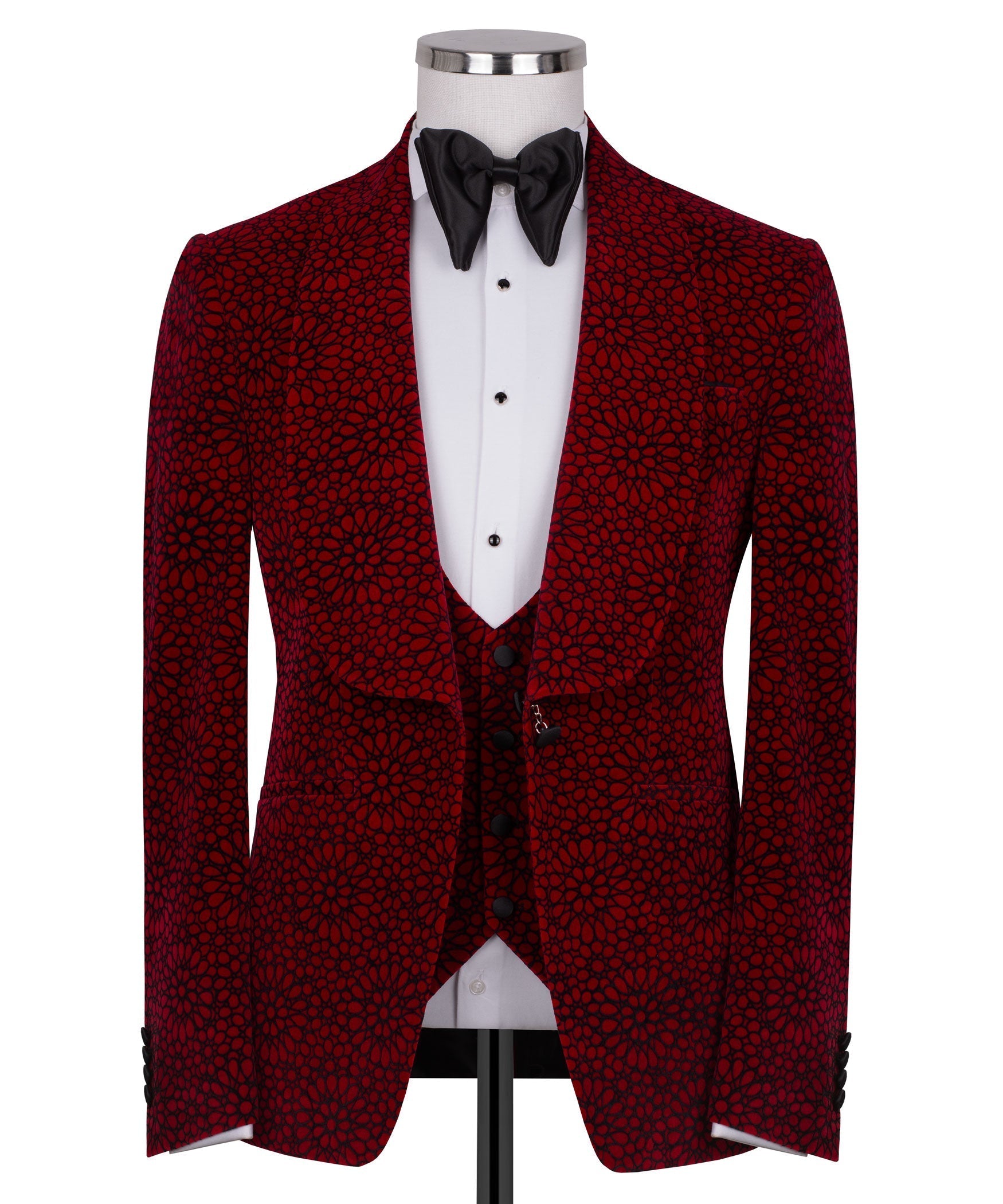 Red patterned tuxedo jacket with black satin bow tie over white vest and shirt