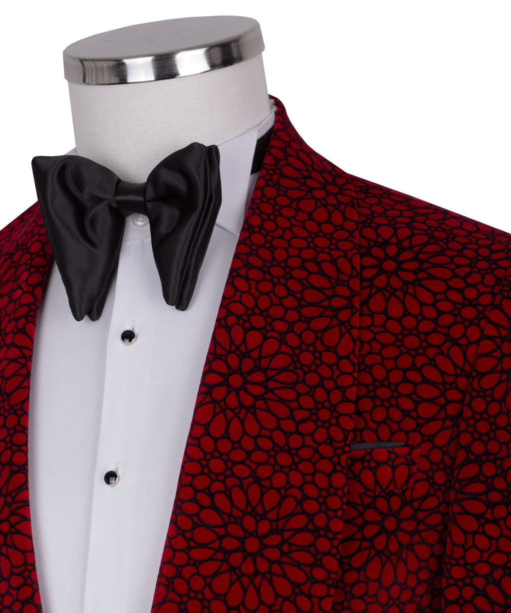 Close-up of black bow tie and red patterned tuxedo lapel with white shirt buttons