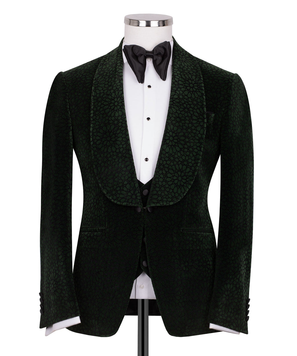 Green velvet tuxedo jacket with black vest and black bow tie, tailored formal look