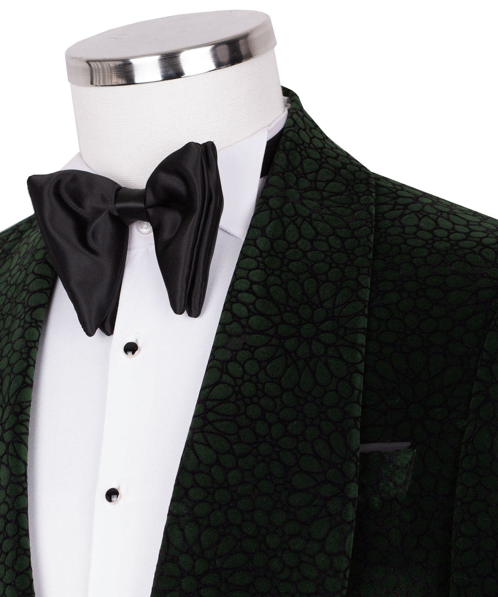 Close-up of black bow tie and white shirtfront with green patterned tuxedo lapel