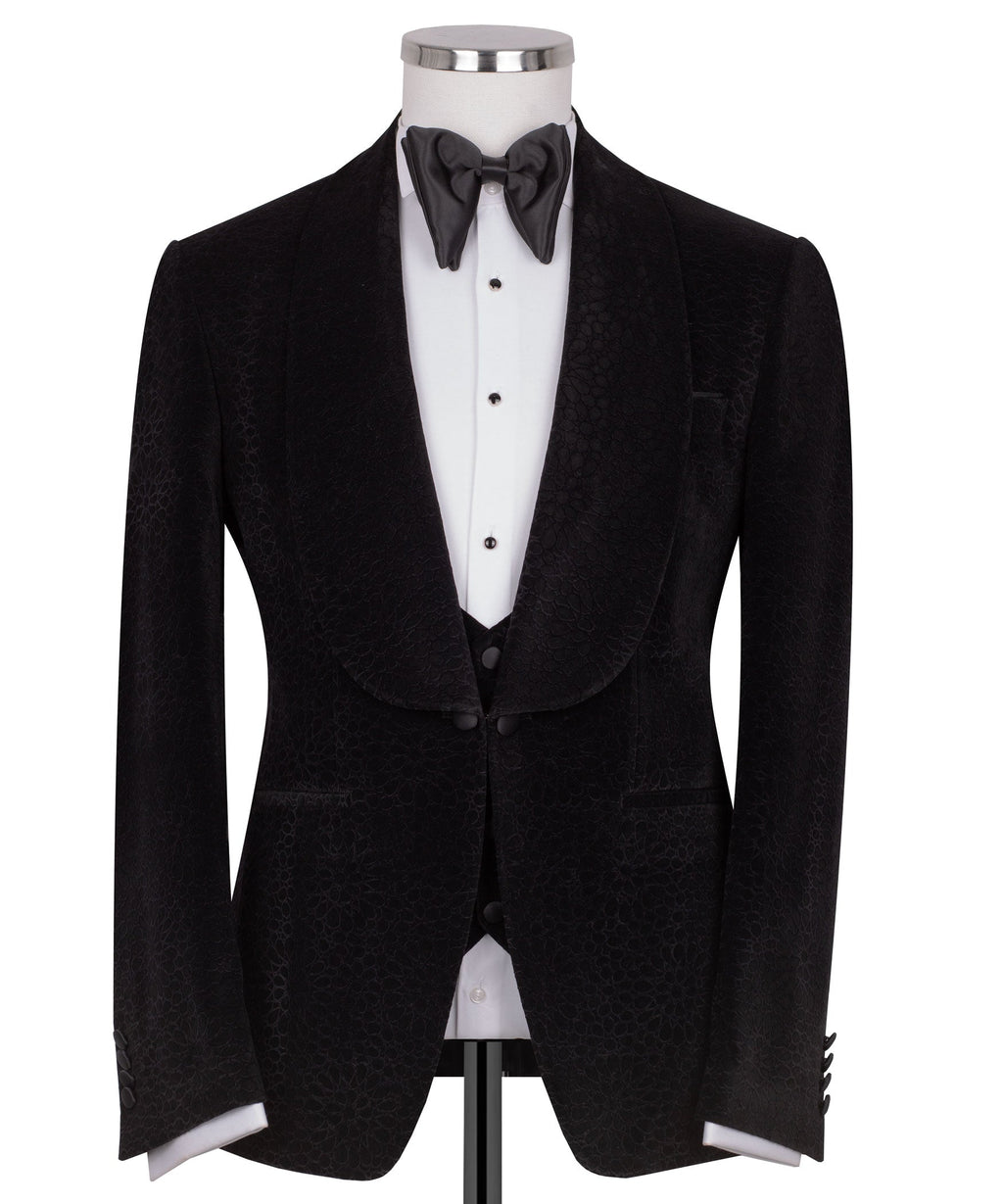Black velvet tuxedo jacket with shawl lapel and satin bow tie over vest
