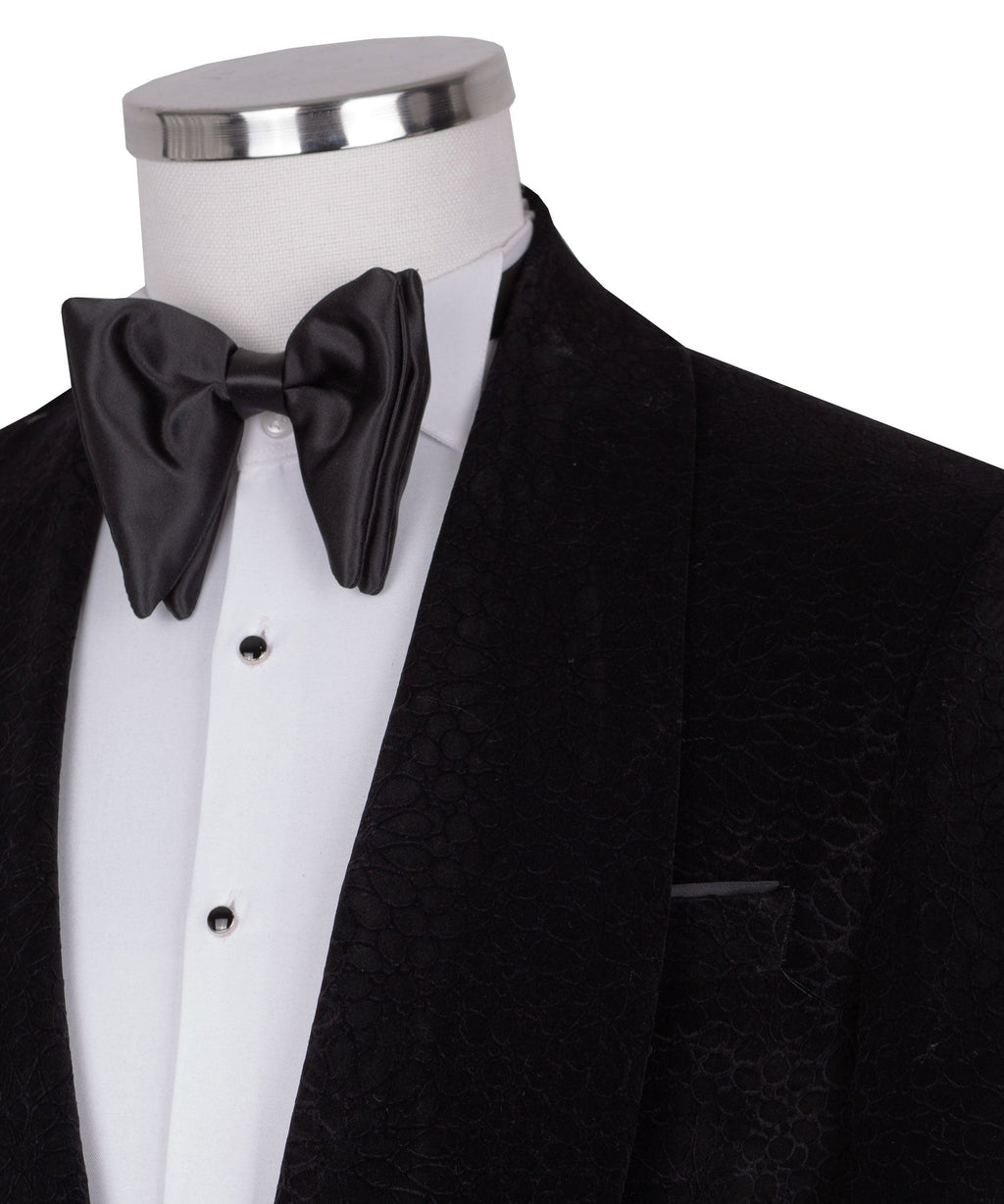 Close-up: black velvet tuxedo jacket with satin bow tie and shirt front