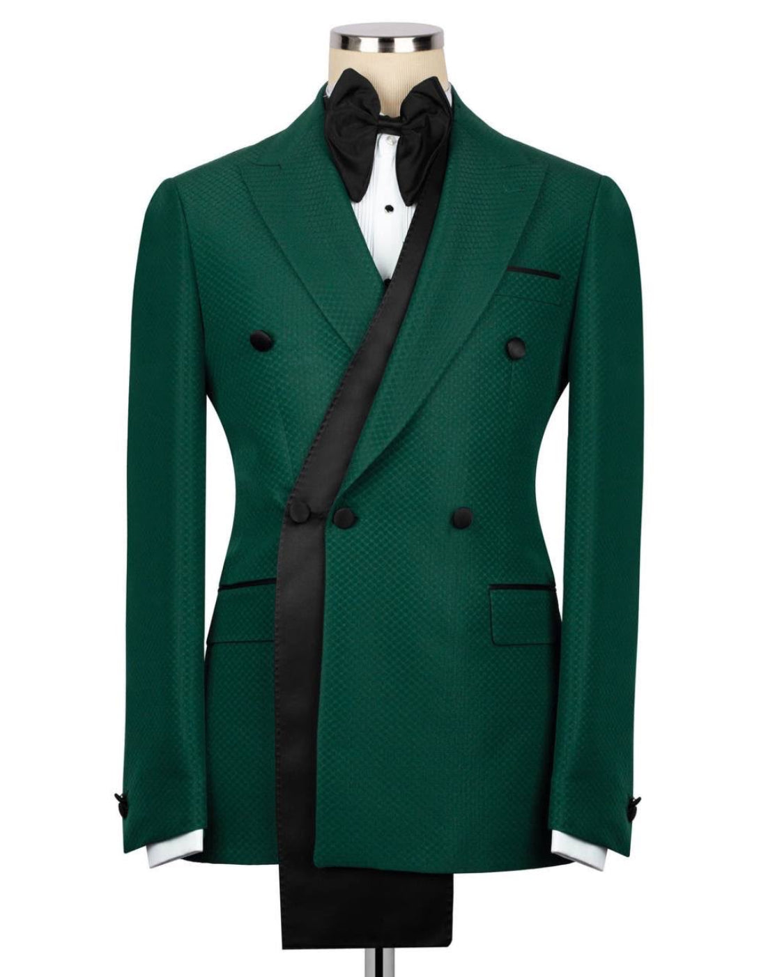Green double-breasted suit jacket with black lapels on a mannequin 