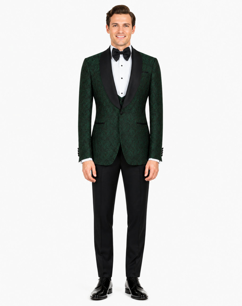 A man modeling a dark green textured tuxedo jacket with black satin lapels, paired with black trousers, a white dress shirt, and a black bow tie