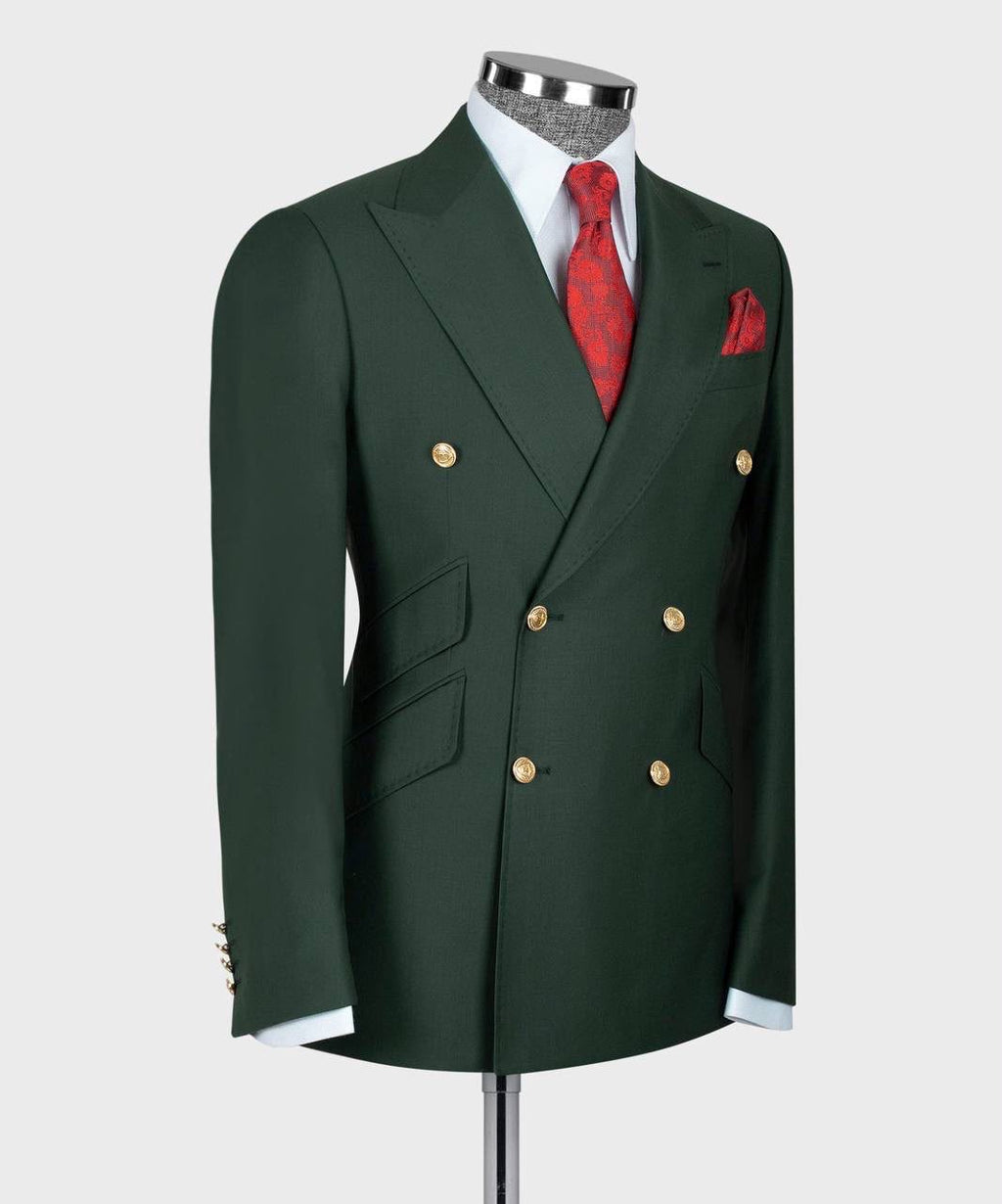 A dark green double-breasted suit jacket displayed on a mannequin torso, styled with a white dress shirt, a red patterned tie, and a matching red pocket square 