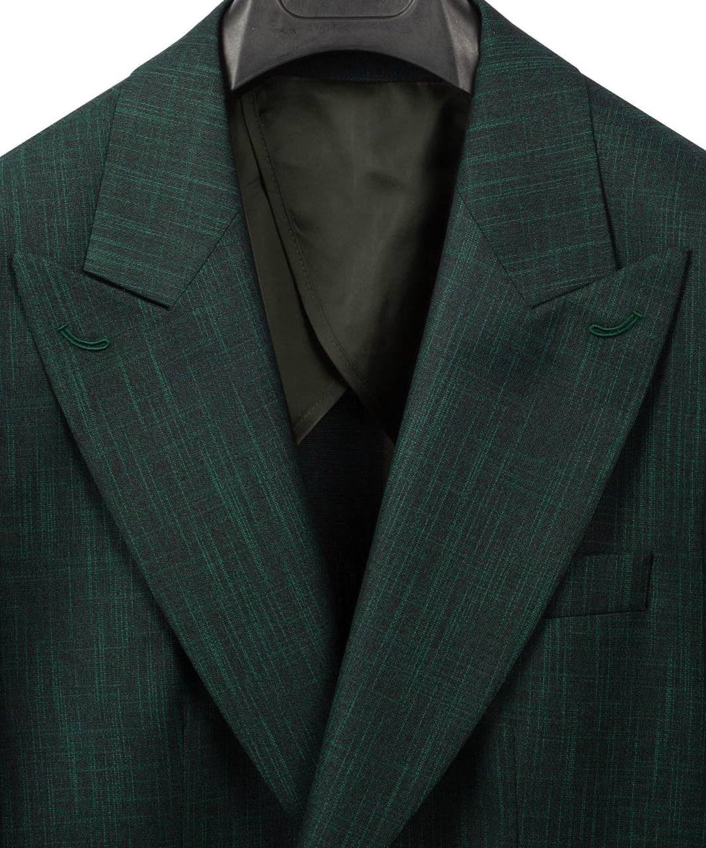 A close-up of a dark green pinstripe suit jacket with notched lapels, displayed on a hanger against a white background.