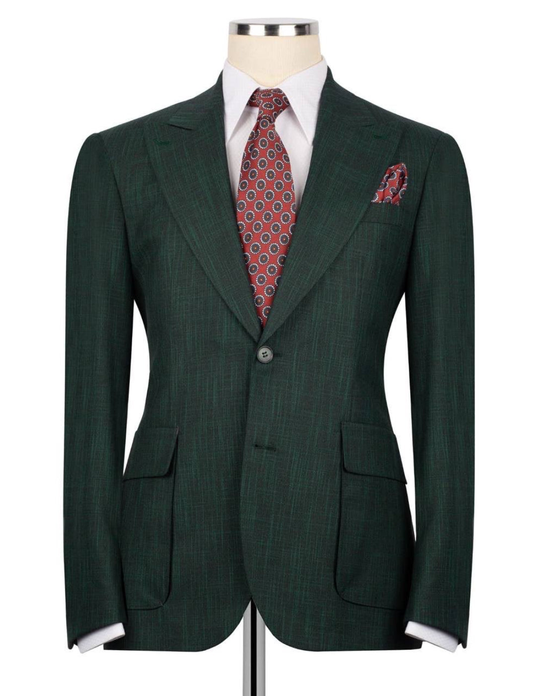A dark green pinstripe suit jacket displayed on a mannequin torso, styled with a white dress shirt, a red and blue patterned tie, and a matching pocket square against a plain white background.