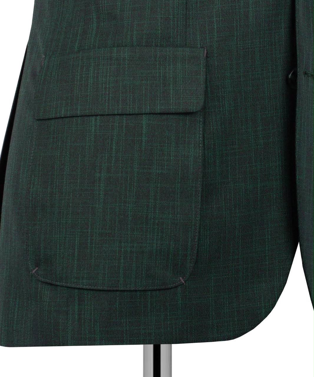 Close-up of a dark green textured blazer jacket with a large flap pocket, displayed on a mannequin against a white background.