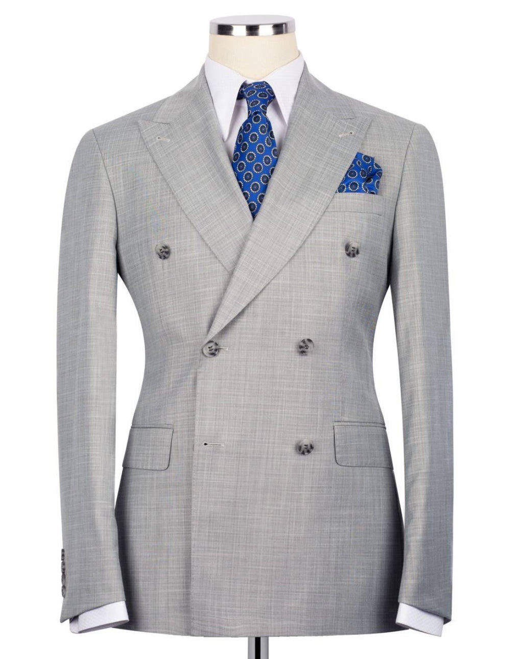 A light gray double-breasted suit jacket with a subtle micro-check pattern, displayed on a mannequin torso with a white dress shirt, blue patterned tie, and matching pocket square.