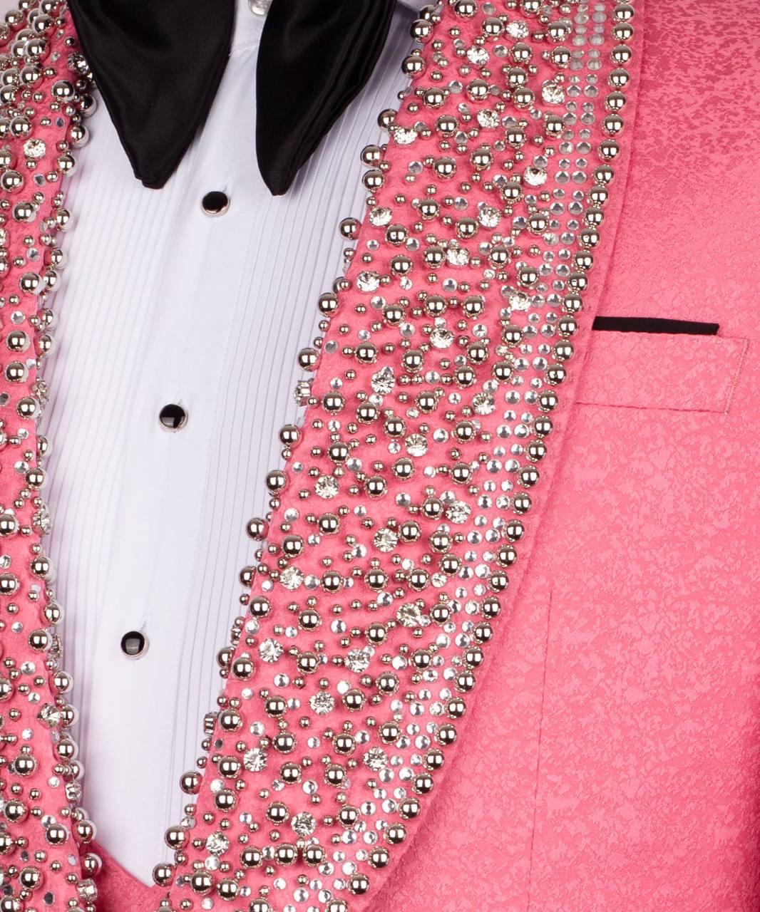 Pink blazer with silver bead detailing on a white shirt.