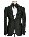 A dark green textured tuxedo jacket with green bead and sequin embellishments, displayed on a mannequin with a black bow tie and white shirt.