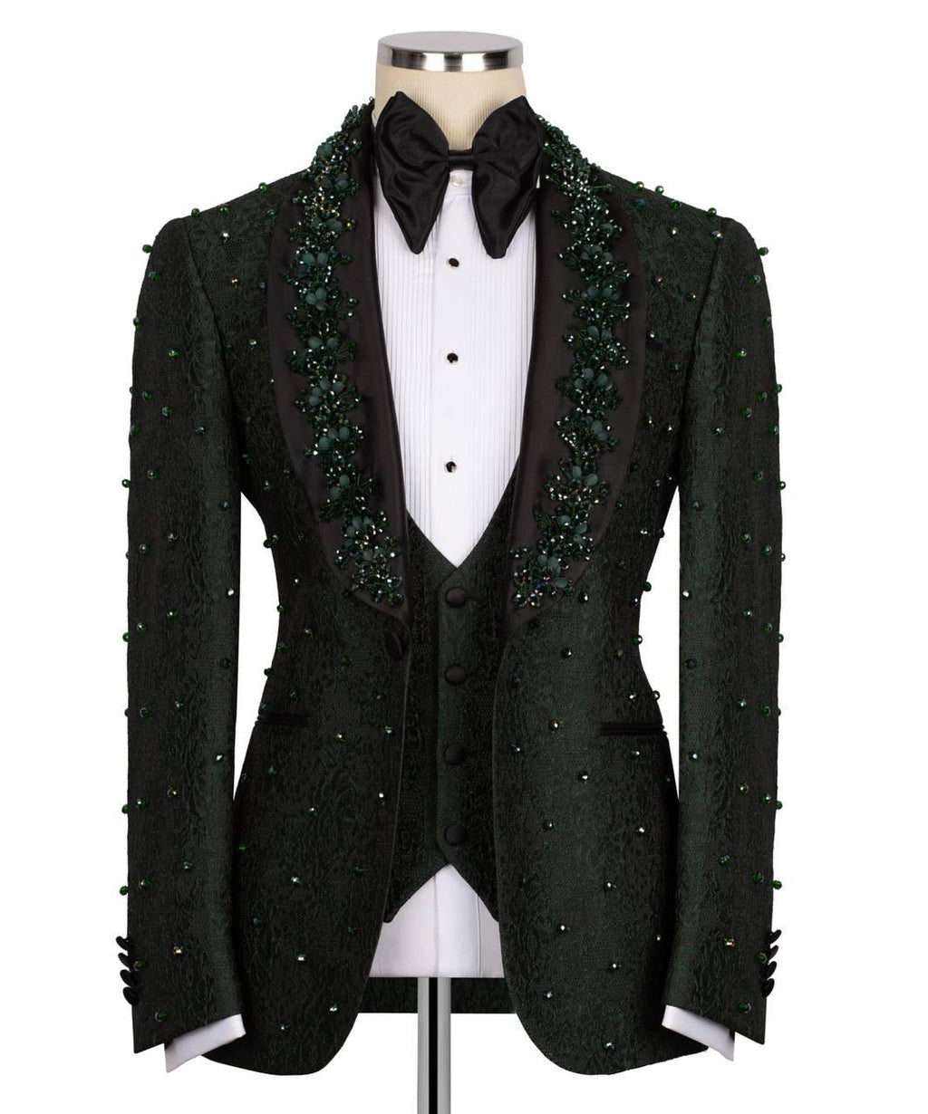 A black tuxedo jacket with green beaded lace trim along the peak lapels and down the sleeves, displayed on a mannequin with a white pinstripe shirt, black bow tie, and matching vest against a white background.