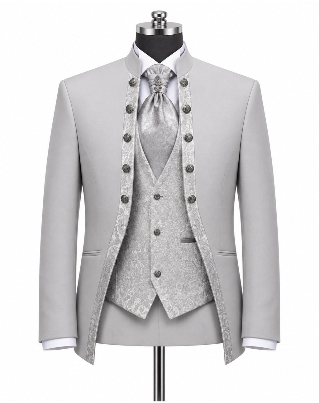 A light gray three-piece formal suit displayed on a mannequin, featuring a jacket with decorative dark buttons, a matching patterned vest, a patterned tie, and a white dress shirt.