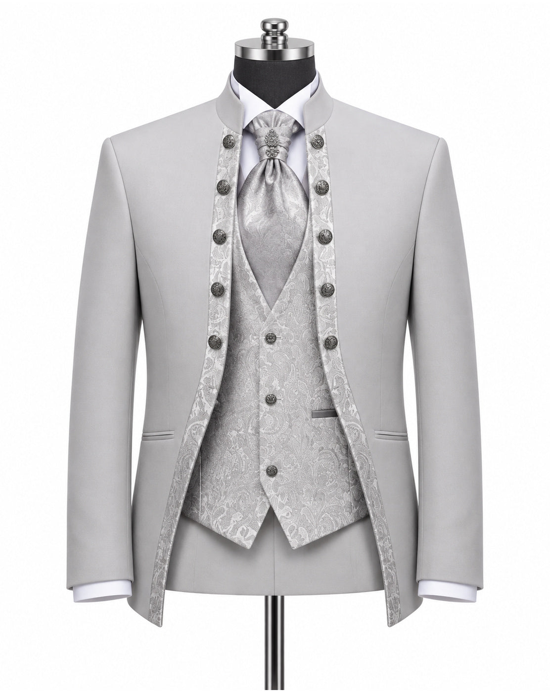 A light gray three-piece formal suit displayed on a mannequin, featuring a jacket with decorative dark buttons, a matching patterned vest, a patterned tie, and a white dress shirt.