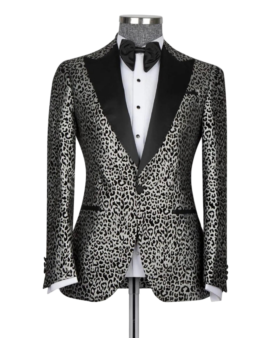 A men's tuxedo jacket with a black and gray leopard print pattern, black satin peak lapels, and a single front button, displayed on a mannequin with a white dress shirt and black bow tie against a light gray background.