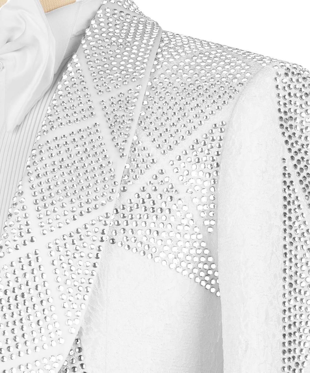 Close-up of a white cardigan with silver embellishments on a hanger.