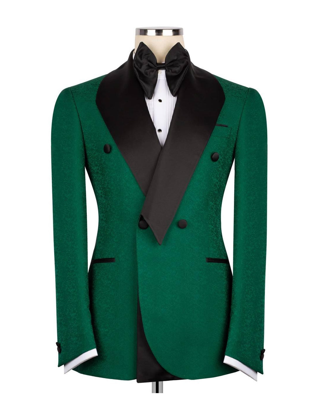 A green double-breasted tuxedo jacket with black satin peak lapels, displayed on a mannequin torso with a black bow tie and white dress shirt against a plain white background.