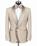A beige double-breasted tuxedo jacket with satin peak lapels, displayed on a mannequin torso with a white dress shirt, beige bow tie, and matching beige buttons.