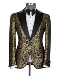 A men's tuxedo jacket with a gold and black leopard print pattern and black satin lapels, displayed on a mannequin with a white tuxedo shirt and black bow tie against a light gray background.