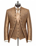 A men's formal three-piece suit displayed on a mannequin, featuring a metallic gold and brown paisley brocade jacket, matching vest, and tie, styled with a white dress shirt and cuffs.