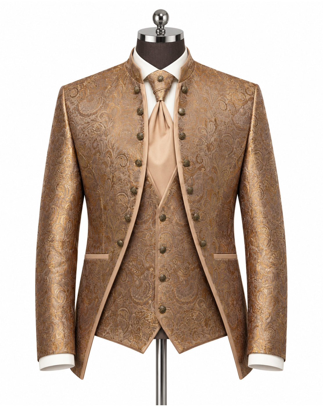 A men's formal three-piece suit displayed on a mannequin, featuring a metallic gold and brown paisley brocade jacket, matching vest, and tie, styled with a white dress shirt and cuffs.