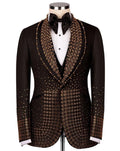 Black tuxedo with gold embellishments on a mannequin against a white background
