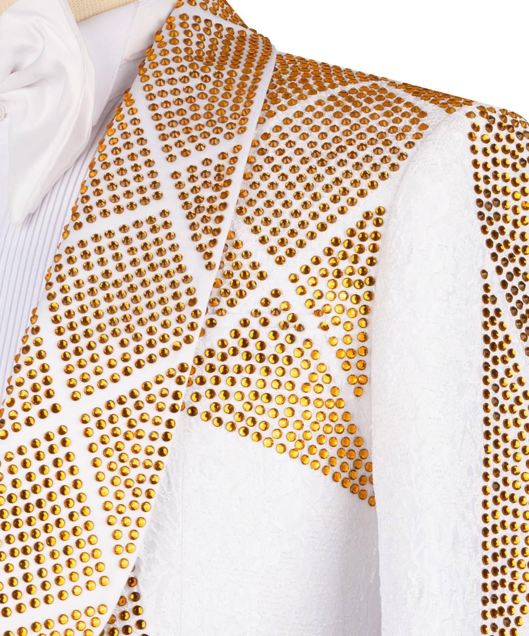 Close-up of a white textured garment, likely a jacket or vest, heavily embellished with geometric patterns of gold rhinestones.