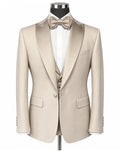 A light beige/tan formal tuxedo jacket with satin peak lapels, displayed on a mannequin with a matching bow tie, white dress shirt, and matching vest against a plain white background.