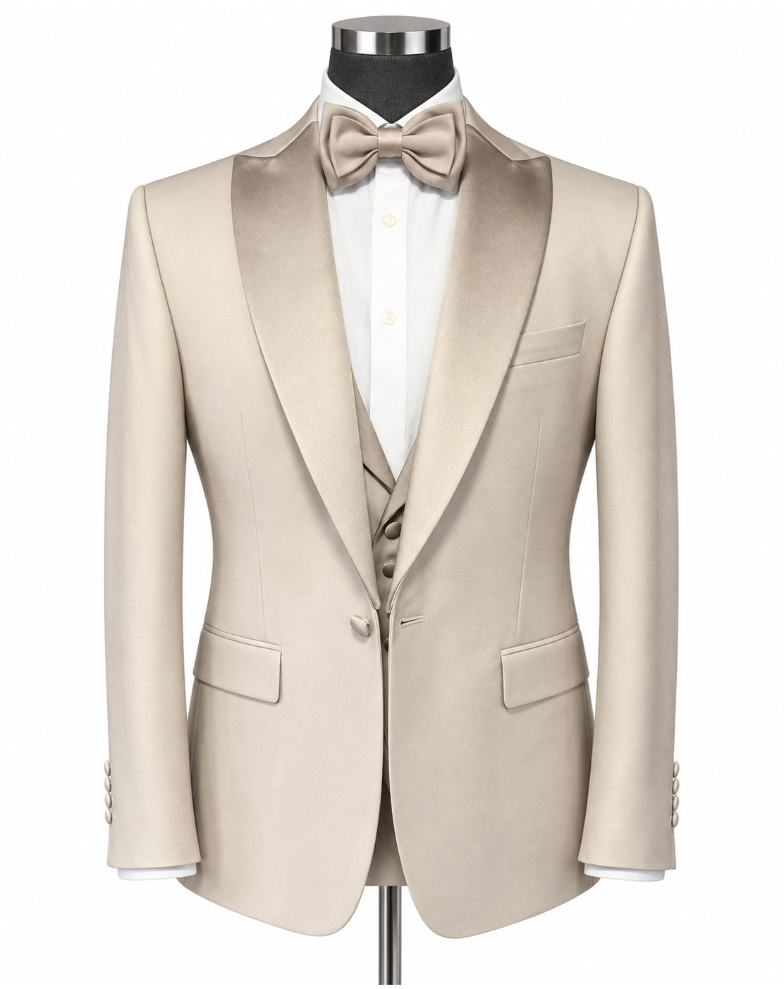 A light beige/tan formal tuxedo jacket with satin peak lapels, displayed on a mannequin with a matching bow tie, white dress shirt, and matching vest against a plain white background.
