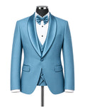 A men's formal tuxedo jacket set in a bright light blue satin-like fabric, displayed on a black mannequin torso with a white pinstripe shirt, matching blue bow tie, and matching blue vest. The background is a clean, light gray studio backdrop.
