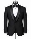A black tuxedo jacket with satin peak lapels, displayed on a mannequin with a white pinstripe shirt, black bow tie, and matching black vest against a plain white background.