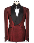 A men's double-breasted tuxedo jacket in a deep burgundy brocade fabric with contrasting black satin shawl collar, black buttons, and a black bow tie, displayed on a mannequin torso.