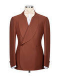 A men's brown double-breasted tuxedo jacket with shawl lapels, displayed on a mannequin torso with a white dress shirt and light beige bow tie against a plain white background.