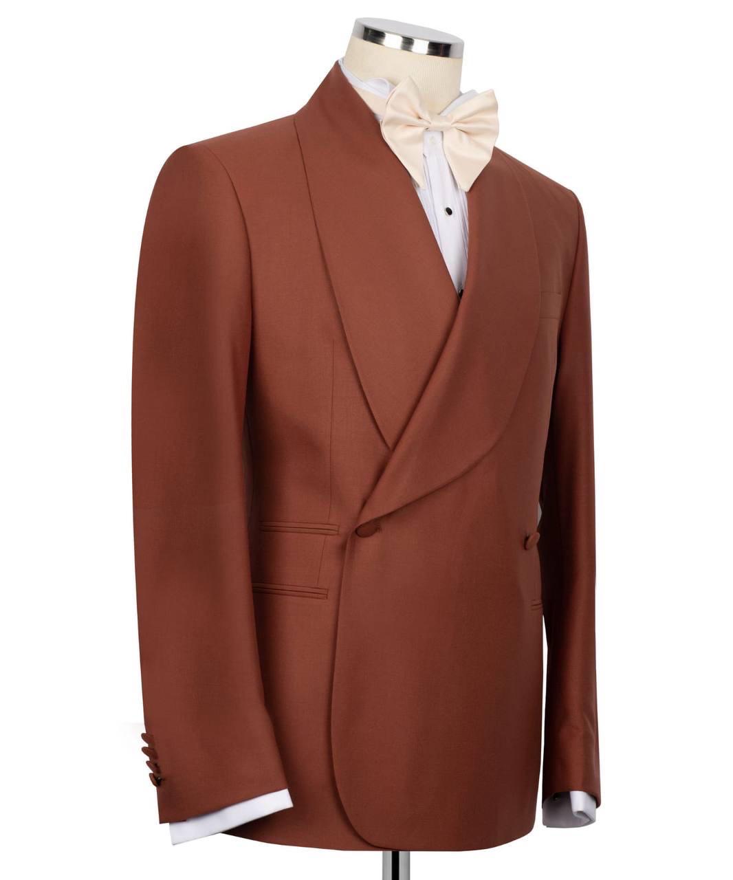 Brown blazer on a mannequin with a white shirt and bow tie against a white background