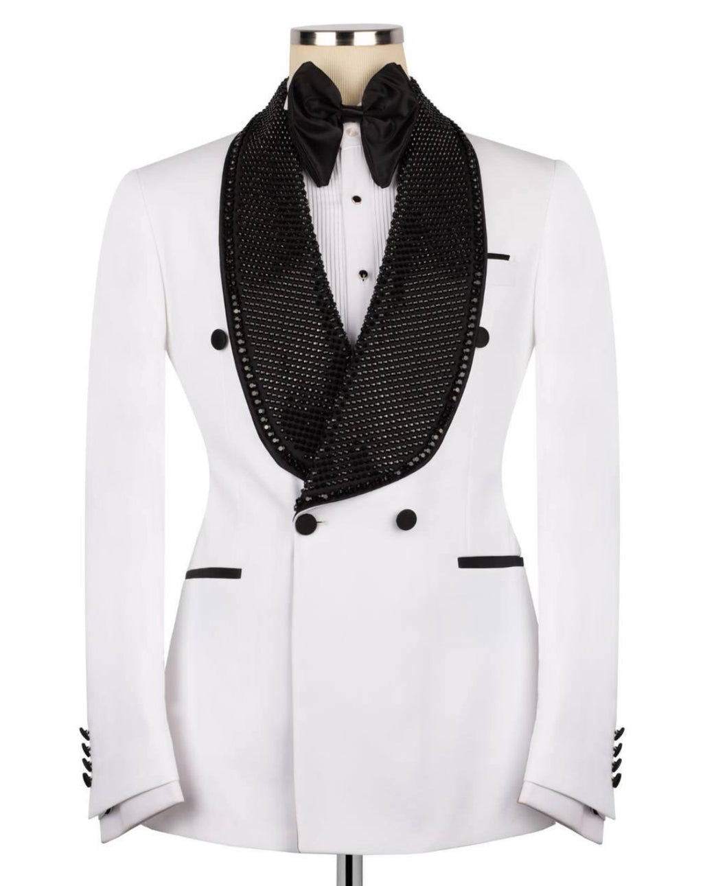 A white double-breasted tuxedo jacket with a black mesh shawl collar, black bow tie, and black button accents, displayed on a mannequin against a white background.