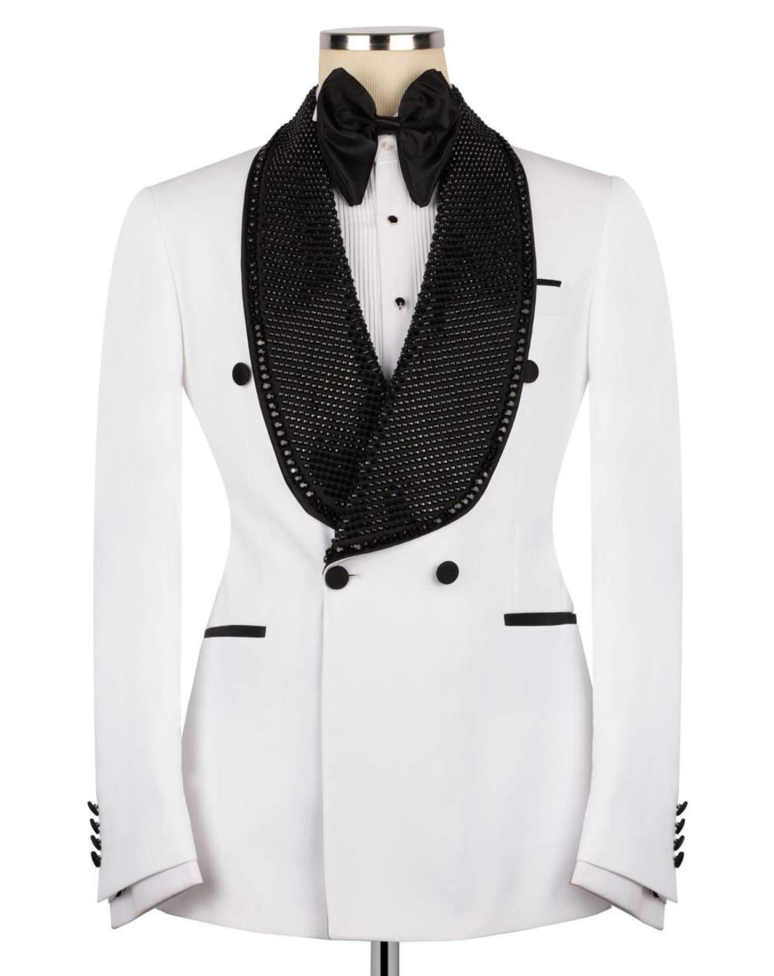 A white double-breasted tuxedo jacket with a black mesh shawl collar, black bow tie, and black button accents, displayed on a mannequin against a white background.