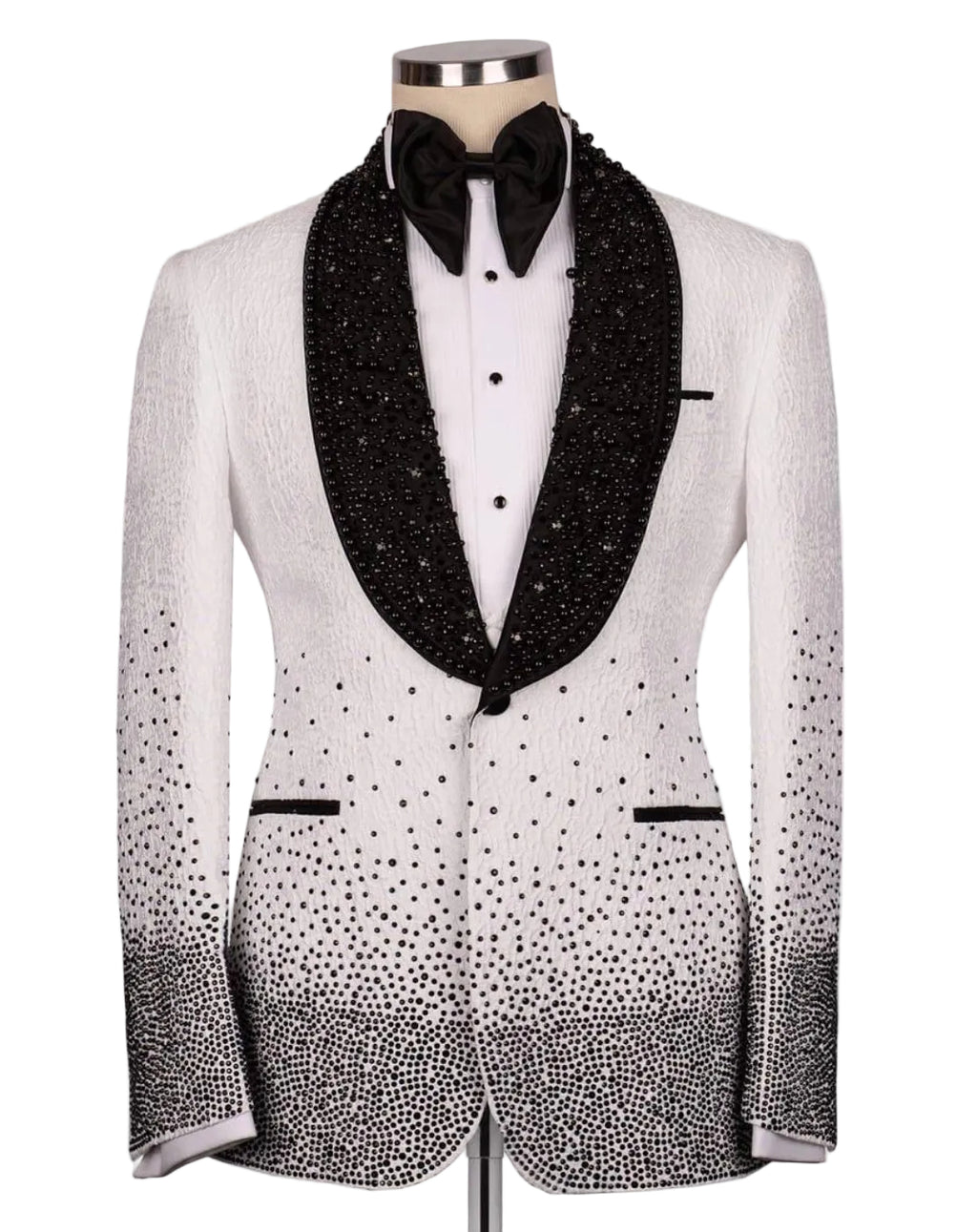 A white tuxedo jacket with black beaded lapels, a black bow tie, and black rhinestone gradient detailing on the lower front and sleeves, displayed on a mannequin against a light gray background.