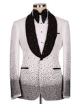 A white tuxedo jacket with black beaded lapels, a black bow tie, and black rhinestone gradient detailing on the lower front and sleeves, displayed on a mannequin against a light gray background.