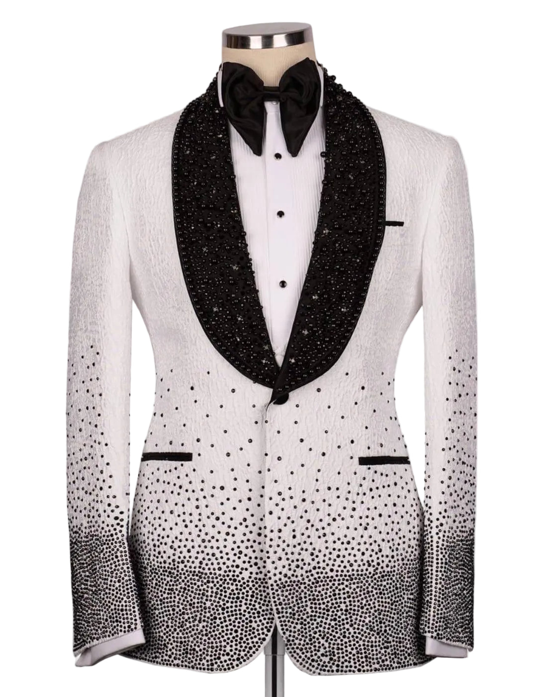 A white tuxedo jacket with black beaded lapels, a black bow tie, and black rhinestone gradient detailing on the lower front and sleeves, displayed on a mannequin against a light gray background.