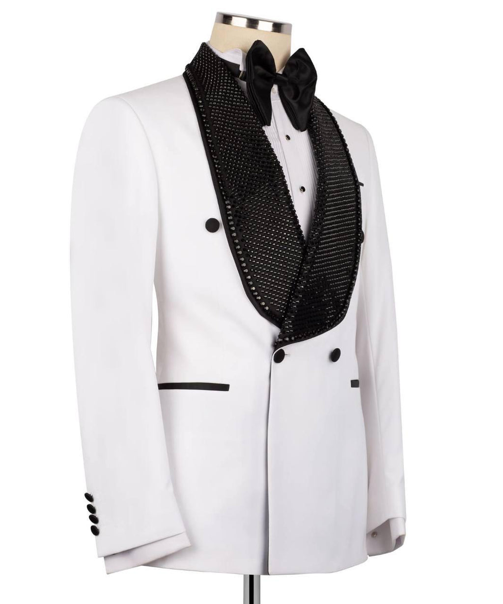 A white tuxedo jacket with a double-breasted front, featuring a black beaded tuxedo lapel, a black bow tie, and black button accents, displayed on a mannequin torso against a white background.