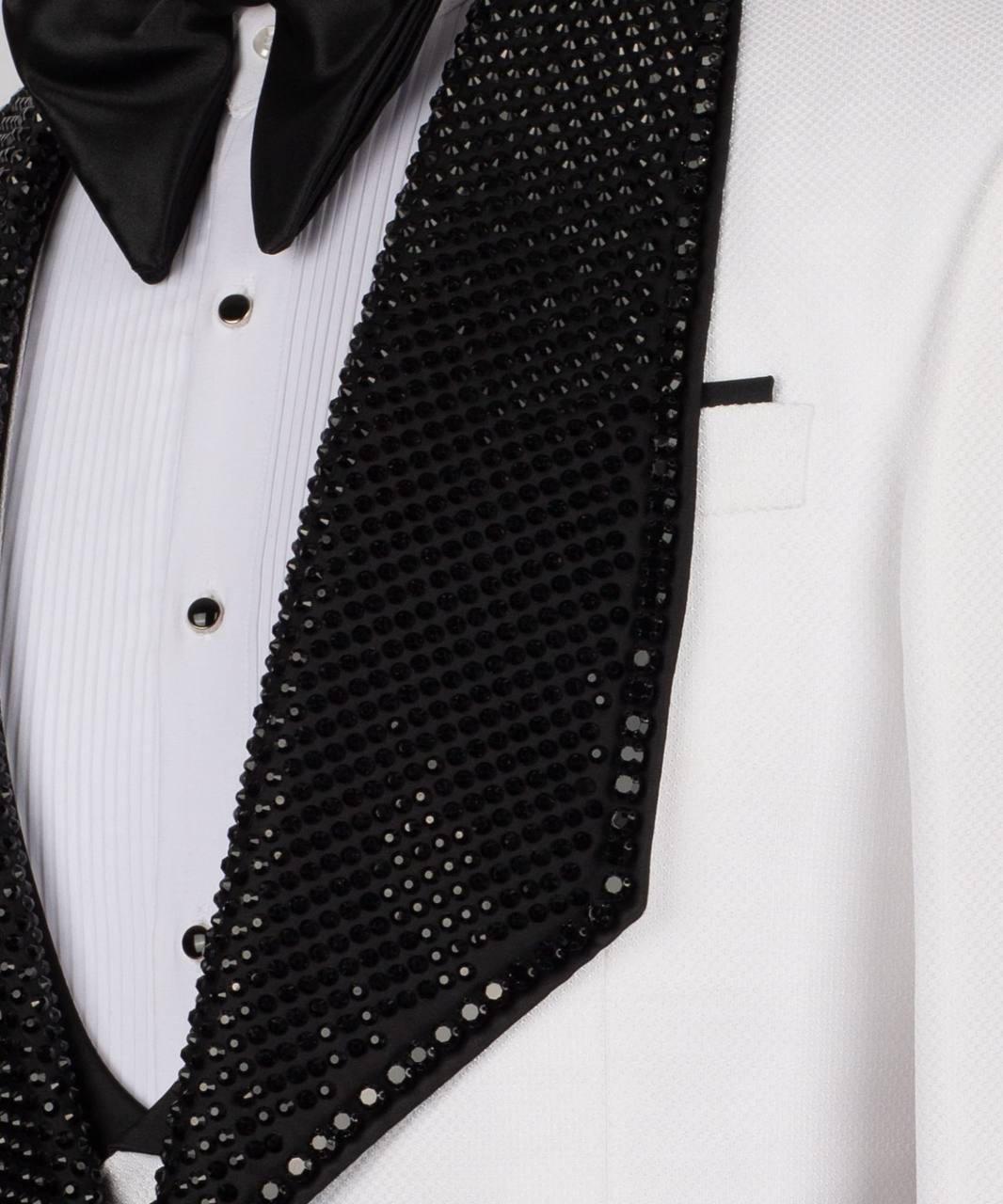 Black sequined vest over a white tuxedo on a white background